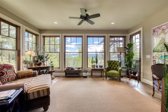 sunroom with ceiling fan and plenty of natural light