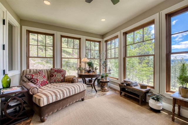 sunroom / solarium featuring ceiling fan