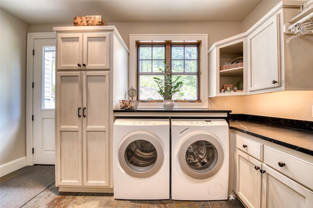 laundry room featuring cabinets and washing machine and dryer