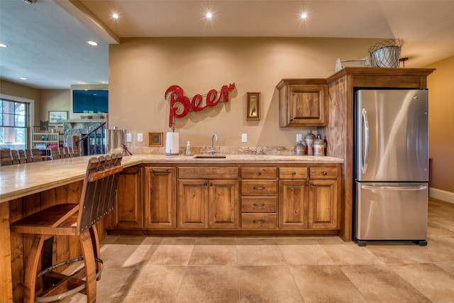 kitchen featuring stainless steel fridge and sink