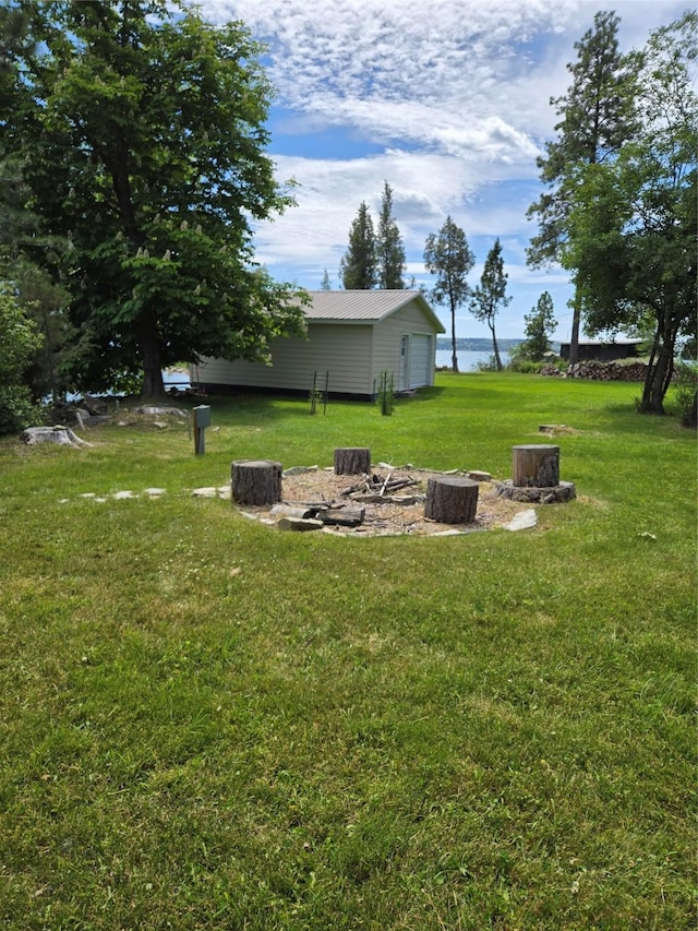 38648 Masumola Rd, Polson, MT 59860 - view of yard with a fire pit and an outdoor structure
