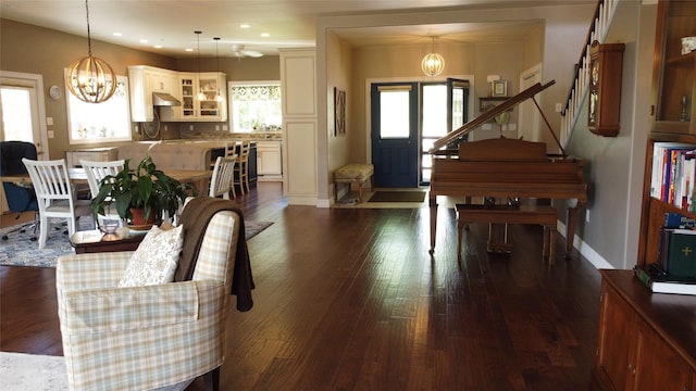 38648 Masumola Rd, Polson, MT 59860 - living room featuring dark wood-style floors, a wealth of natural light, and a chandelier