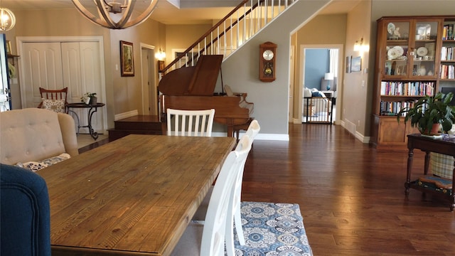 38648 Masumola Rd, Polson, MT 59860 - dining area featuring baseboards, wood finished floors, stairway, and an inviting chandelier