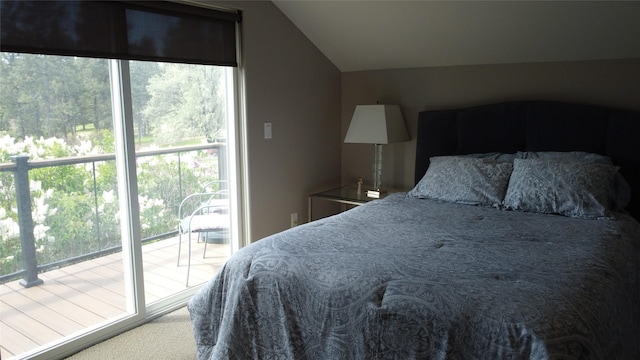 38648 Masumola Rd, Polson, MT 59860 - carpeted bedroom with access to exterior, vaulted ceiling, and multiple windows