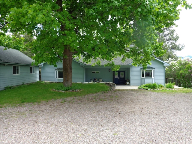 38648 Masumola Rd, Polson, MT 59860 - ranch-style home featuring a front lawn and a shingled roof