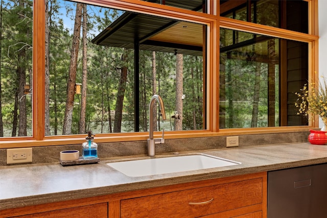 kitchen featuring sink and light stone countertops