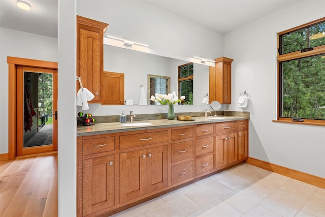 kitchen with a wealth of natural light, sink, and light tile floors