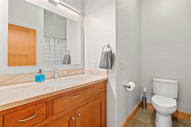 bathroom with tile flooring, toilet, and large vanity