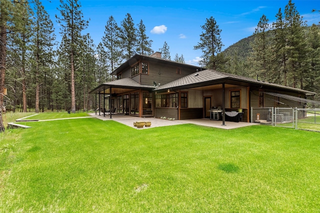 rear view of house featuring a patio area and a yard