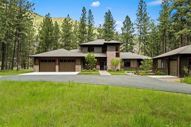 prairie-style home with a front yard and a garage