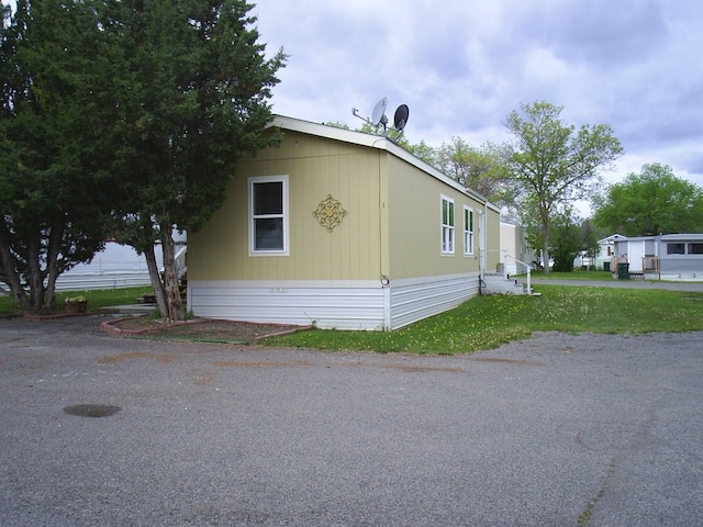 view of side of home featuring a lawn