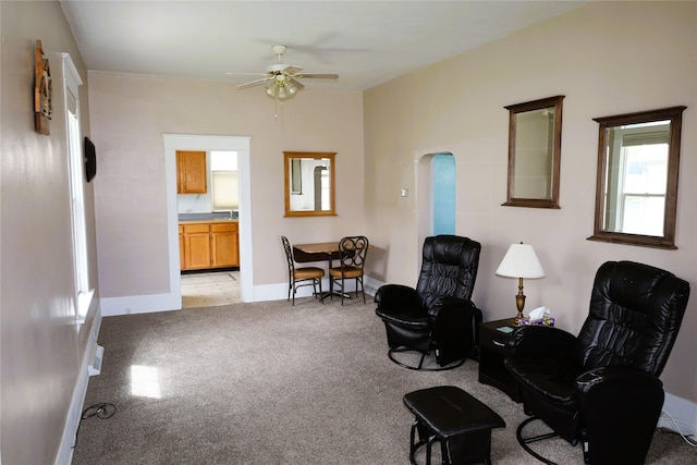 sitting room featuring light carpet and ceiling fan