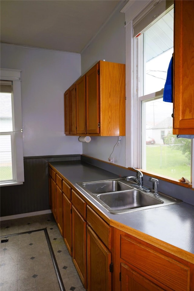 kitchen with tile patterned flooring, a healthy amount of sunlight, and sink