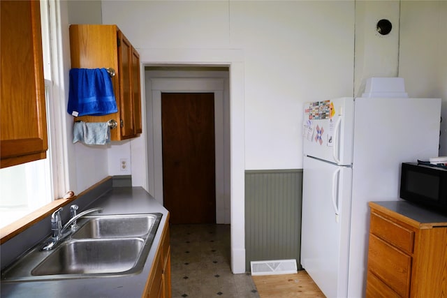 kitchen with white refrigerator and sink