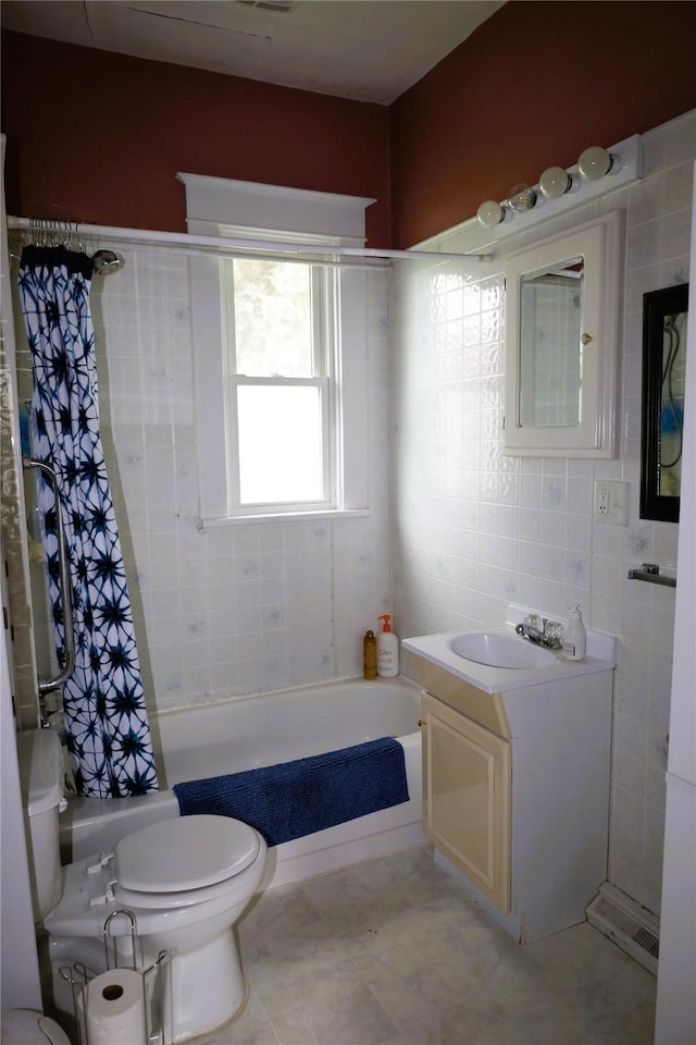 full bathroom featuring shower / tub combo, vanity, toilet, and tile walls