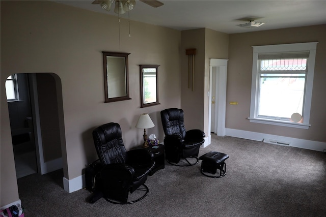 sitting room with carpet flooring, a wealth of natural light, and ceiling fan