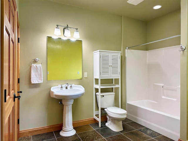 bathroom with tile patterned flooring, tub / shower combination, and toilet