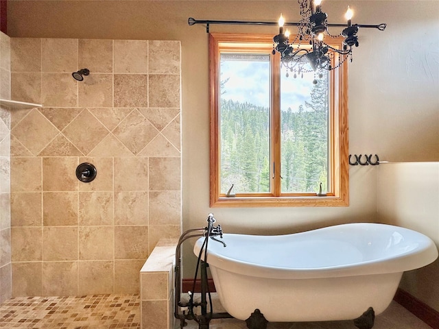 bathroom featuring a notable chandelier, shower with separate bathtub, and a wealth of natural light