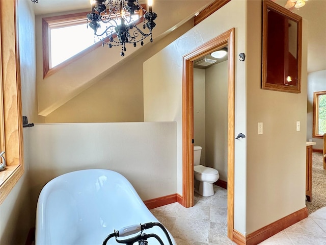 bathroom featuring toilet, a bathing tub, and tile patterned flooring