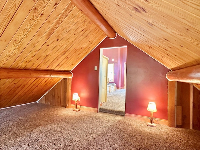 additional living space featuring carpet floors, vaulted ceiling with beams, and wooden ceiling