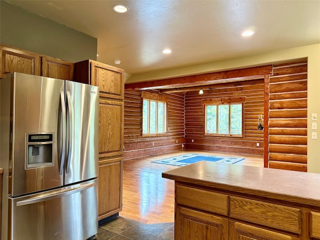 kitchen with dark hardwood / wood-style flooring and stainless steel refrigerator with ice dispenser