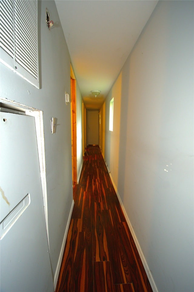 corridor with hardwood / wood-style floors