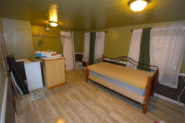 bedroom with light hardwood / wood-style floors