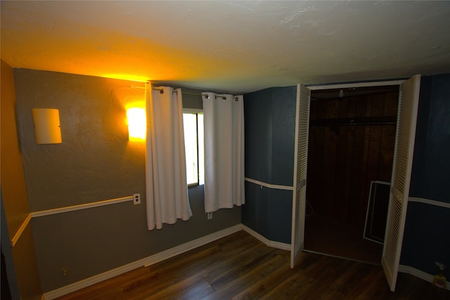 unfurnished bedroom featuring dark hardwood / wood-style flooring