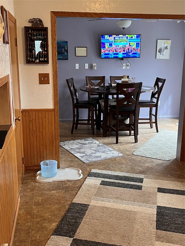 dining room featuring wood walls