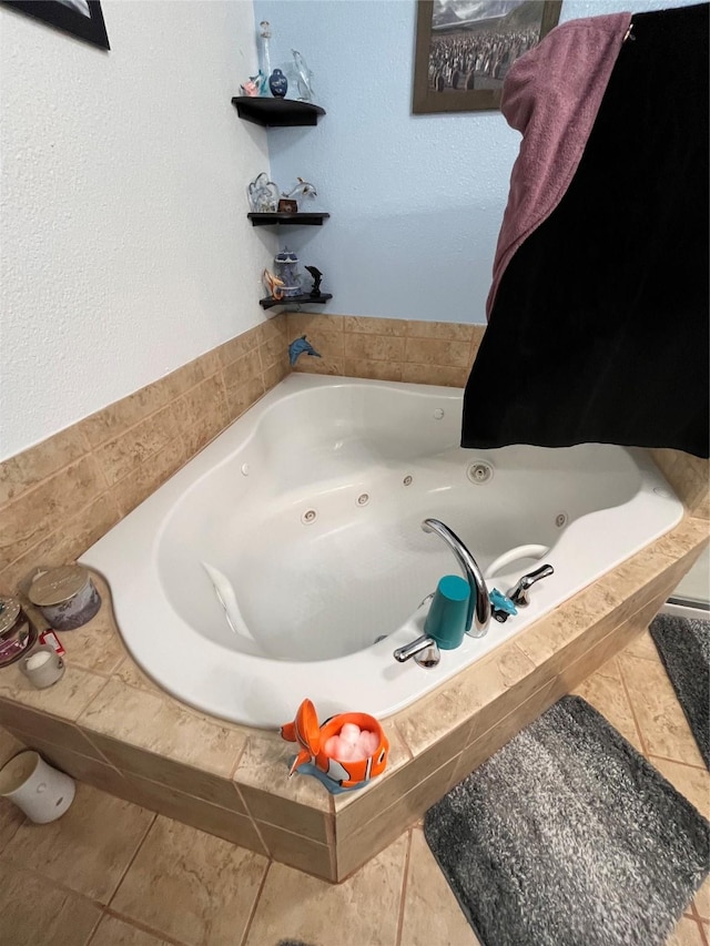 bathroom featuring tile patterned floors and a relaxing tiled tub