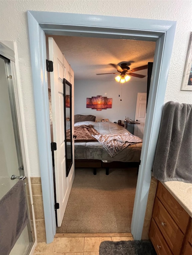 bedroom featuring ceiling fan and light colored carpet