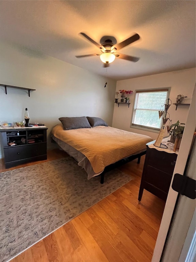 bedroom with hardwood / wood-style flooring and ceiling fan