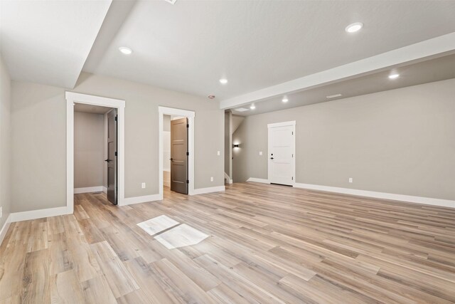 unfurnished bedroom featuring a walk in closet and light hardwood / wood-style flooring