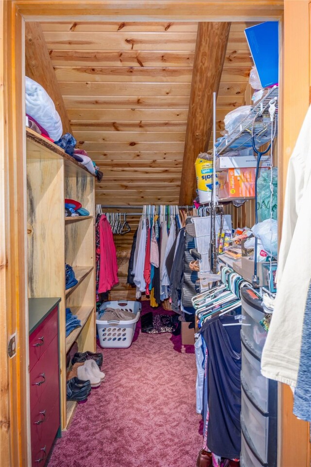 walk in closet with carpet flooring and lofted ceiling