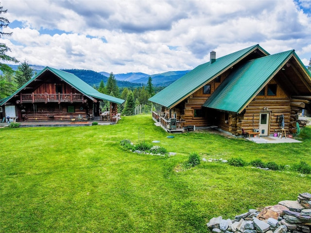 view of yard featuring a deck with mountain view