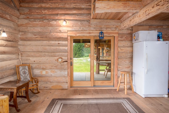 interior space featuring beam ceiling, hardwood / wood-style flooring, rustic walls, and wood ceiling