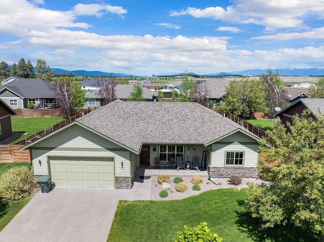 single story home with a residential view, stone siding, fence, and a front lawn