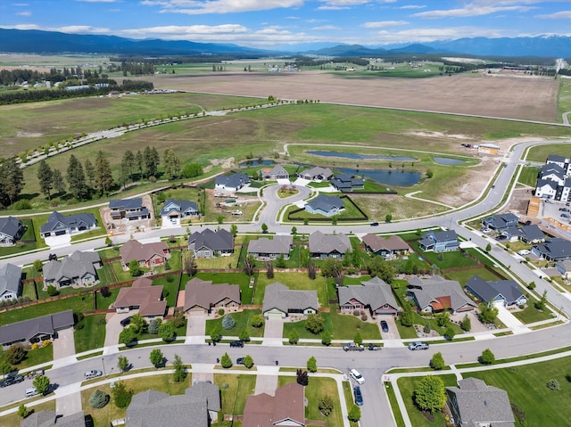 birds eye view of property with a residential view and a water and mountain view