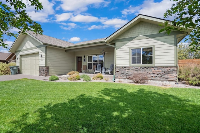 view of front of property featuring a garage, stone siding, and a front lawn