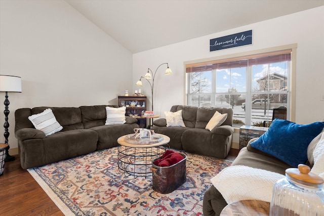 living area featuring lofted ceiling and wood finished floors