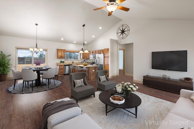 living room featuring baseboards, high vaulted ceiling, light wood finished floors, and recessed lighting