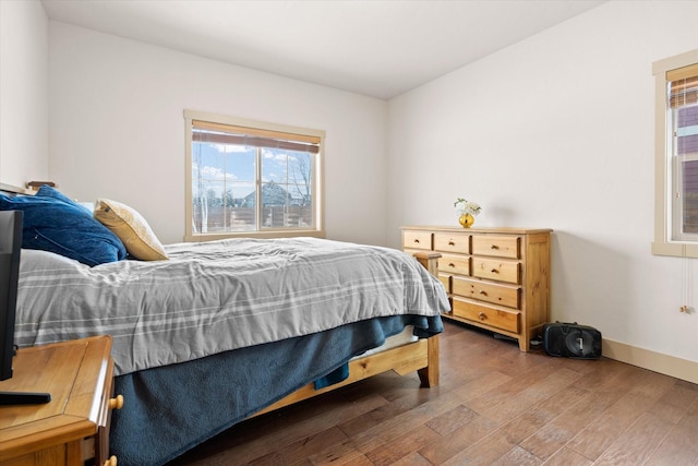 bedroom with wood finished floors and baseboards