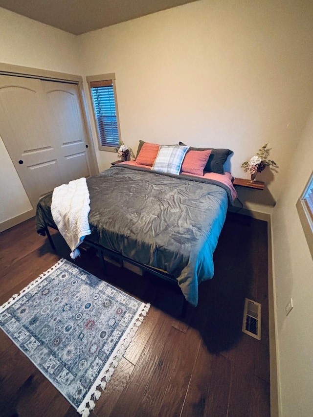 bedroom with wood finished floors and visible vents