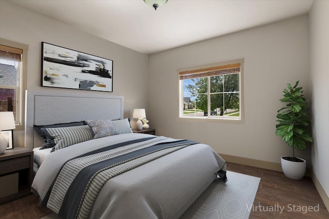 bedroom featuring baseboards and wood finished floors