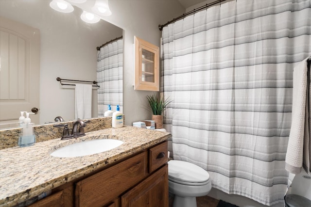 full bath featuring curtained shower, vanity, and toilet