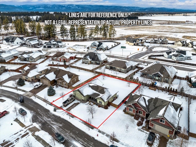 snowy aerial view with a residential view