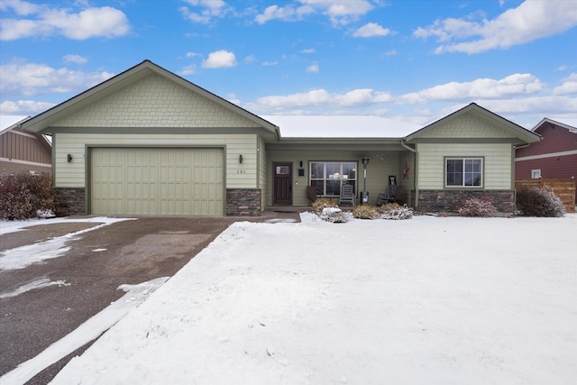 view of front of home with an attached garage and stone siding