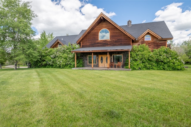 625 Middle Burnt Fork Rd, Stevensville, MT 59870 - back of property featuring a chimney, a lawn, and covered porch
