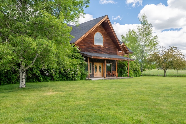 rear view of property featuring a yard