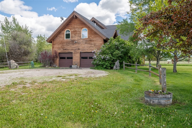 view of property exterior with a garage and a yard